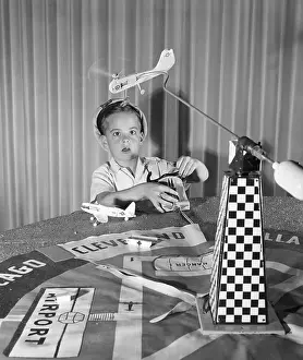 Exhibit Prints: Child Playing With Flying Helicopter