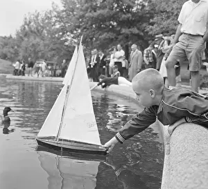 Artificial Lake Prints: Child Playing With Model Boat At Park