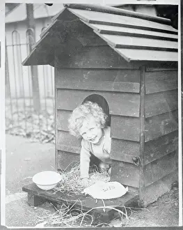 Child Sitting in a Doghouse