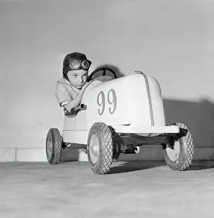 Child Sitting in Toy Car