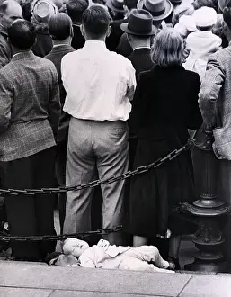 Ignoring Prints: Child Sleeping Behind People Watching Pa