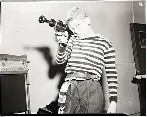 Aiming Prints: Child Takes Aim with Futuristic Toy Gun