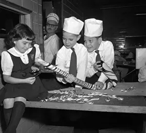 10 12 Years Prints: Children (10-12) preparing large candy cane
