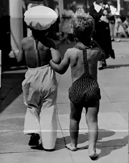 Prints of circa 1950: Two young children wearing beachwear walking arm-in-arm. (Photo by Fox Photos/Getty Images) Timeless Treasures: Iconic Black and White Prints from the Fox Photo Library: Two Children