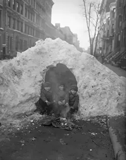 Snowdrift Prints: Three children (4-7) sitting by fire in snowy street