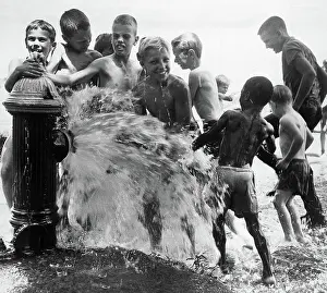 Spraying Prints: Children Bathe in Fire Hydrant Spray