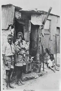 Disrepair Prints: Children in Front of Dwelling