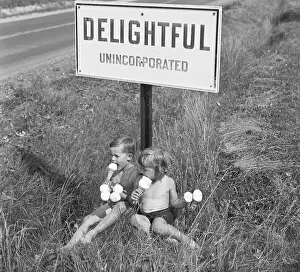Children Eating Ice Cream Under Sign