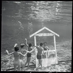 Submerged Prints: Children Frolicking Near Waters Edge