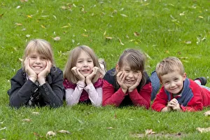 Merry Prints: Four children lying on a meadow