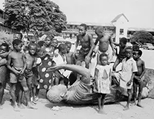 Accra Prints: Children Play on Fallen Statue