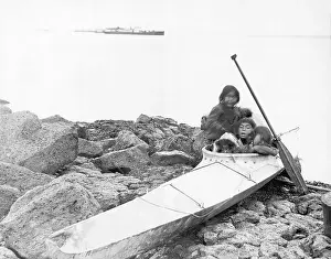 Paddle Prints: Children Playing In Kayak On Shore
