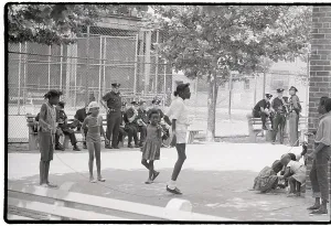 Playground Prints: Children Playing Near Group of Police Officers