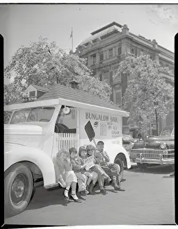 Children with Sign Sitting on Ice Cream Truck