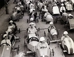 Children Sit in Soapbox Derby Cars