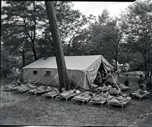 Napping Prints: Children Sleep On Cots Outside Of Tent