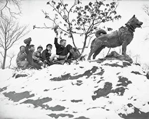 Children on Sleigh Near Statue Dedicated to Hero Dog