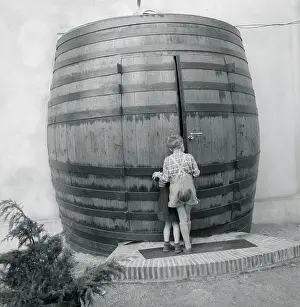 Children Standing in Front Huge Barrel Shaped Building