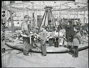 Carousel Prints: Children Watch Man Fix Merry Go Round