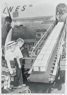 Children Watching Boxes on a Conveyor Belt