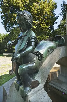 Music Instrument Prints: Childs sculpture with musical instrument and fish fin on Minnesangerbrunnen fountain