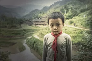 Images Dated 20th June 2006: Chinese boy standing in rice paddy fields