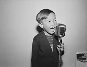 Chinese Boy Telling Story at Microphone
