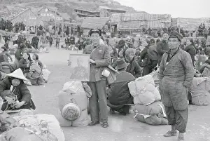 Chinese Citizens Sitting and Standing at Evacuation Field