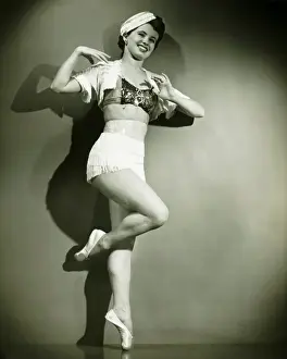 Enjoyment Prints: Chorus girl dancing in studio, (B&W)