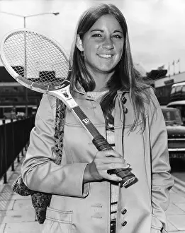 Prints of June 1972: A portrait of American tennis player Chris Evert, wearing a coat and holding a tennis racket over her shoulder, in London to compete in her first Wimbledon tournament, London, England The Grand Slam Gallery: Chris Evert