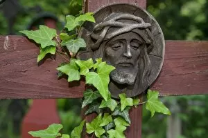 Christian carvings, Jesus with a crown of thorns, historic woodland cemetery stomping ground, military cemetery