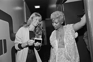Autographing Prints: Christie Brinkley Getting Autograph From Aretha Franklin