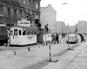 Prints of Christmas Tree put on top of Checkpoint Charlie in Berlin, 12/20/62. (Photo by Express/Archive Photos/Getty Images) Berlin Wall (Antifascistischer Schutzwall) Prints: Christmas Comes To Checkpoint Charlie in Berlin