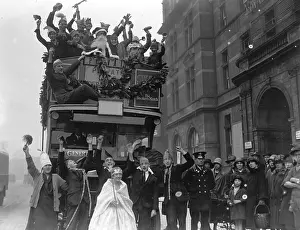 Prints of December 1926: Children from the Royal Caledonian School enjoying a festive Christmas pageant on an open top bus which is carrying Santa and his helpers through the streets Celebrate the Season: A Curated Collection of Christmas Art: Christmas Parade