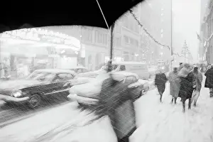 Prints of PHILADELPHIA, PENNSYLVANIA - CIRCA 1963 Celebrate the Season: A Curated Collection of Christmas Art: Christmas Shoppers in the Snow in 1963