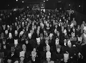 Prints of 24th December 1926: A crowd of children in party hats enjoy a production of Treasure Island as a Christmas treat at the Strand Theatre, London. (Photo by E. Bacon/Topical Press Agency/Getty Images) Topical Press Agency Prints: Christmas Treat