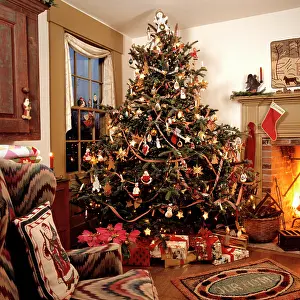 Prints of 1990s Americana Theme Traditional Decorated Living Room Christmas Presents Under Tree Fireplace With Stocking Wing Chair (Photo by A Teufen/Classicstock/Getty Images) Celebrate the Season: A Curated Collection of Christmas Art: Christmas Tree
