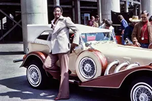 Prints of Professional football player Walter Eugene 'Chuck' Foreman of the Minnesota Vikings poses alongside an Excalibur wearing a double breasted jacket Timeless Moments: A Visual Journey Through History’s Defining Images: Chuck Foreman
