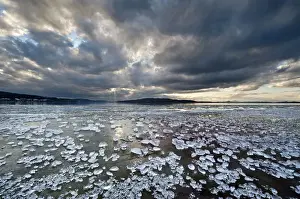 Lakeside Prints: Chunks of ice lying on icy surface on the shore of Reichenau Island