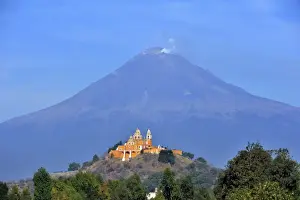 Church of Iglesia Nuestra Senora de los Remedios on the ruins of the pre-Hispanic Pyramid of Cholula in front of the active volcano Popocatepetl, San Pedro Cholula, Puebla, Mexico, Latin America, North America