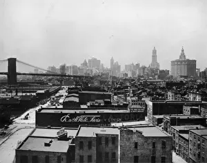 Landscape Road Prints: circa 1920: View of the buildings at South Street Seaport and the Brooklyn Bridge