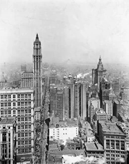 circa 1925: High angle view, looking north, of skyscrapers and traffic on Broadway