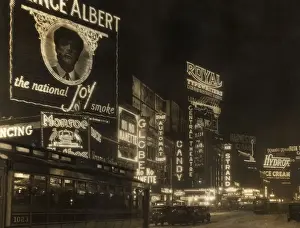 Prints of circa 1926: Automobiles and a streetcar pass illuminated theater marquees and billboards at night in Times Square, New York City. (Photo by Edwin Levick/Hulton Archive/Getty Images) Vibrant Neon Art Prints: circa 1926: Automobiles and a streetcar pass illuminated theater marquees and billboards