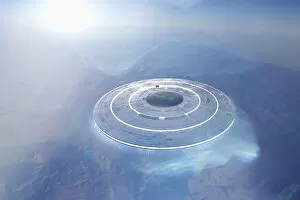Circular UFO flying over mountain landscape