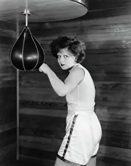 Clara Bow Posing with Punching Bag in Gym Shorts