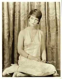 Clara Bow Star Posing in Front of Curtains