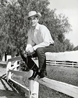 Clark Gable In Cowboy Togs, Sits On Fence