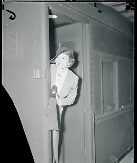 Claudette Colbert Peaking at the Camera From a Door
