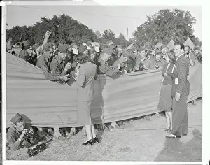 Autographing Prints: Claudette Colbert Signing Autographs for Soldiers