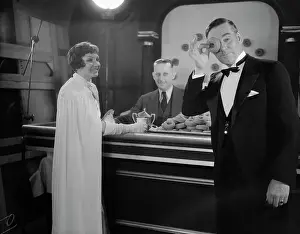 Claudette Colbert and Walter Huston Having Doughnuts